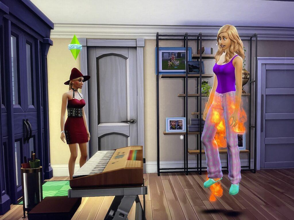 Summer Holiday sets fire to Hannah using her magic powers in The Sims 4 Realm of Magic