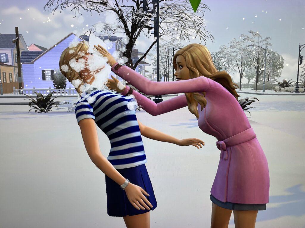 Hannah McCoy shoves a snowball in the face of Summer Holiday in Sims 4 Sim Life Chronicles